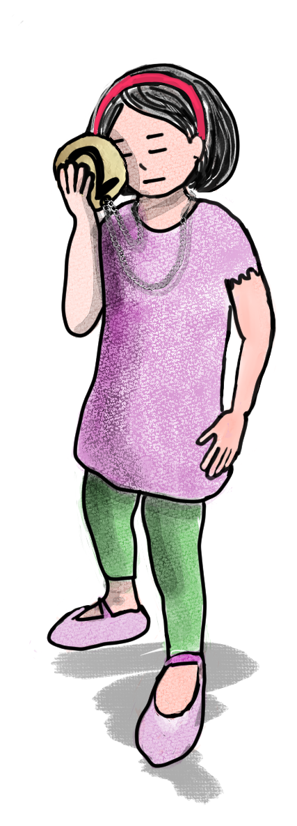 Fleur holding a small medal, looking down